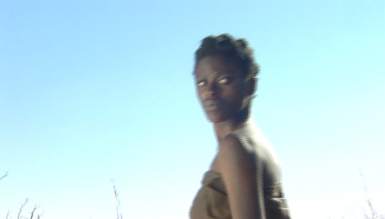 A Black Person looks back over their shoulder