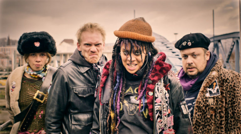 4 people standing on a bridge looking angry into the camera.